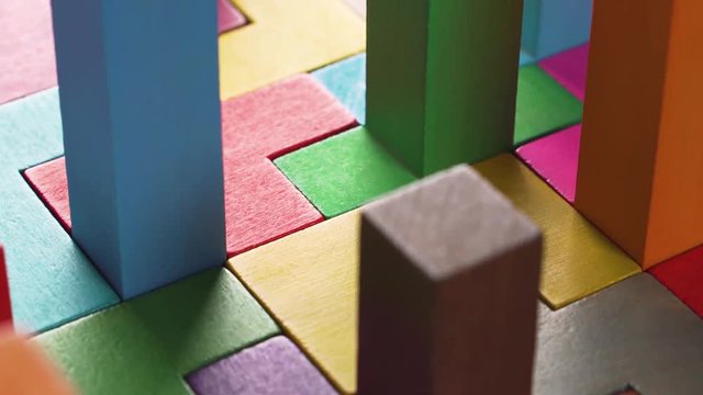 Geometric shapes on a wooden background. Colorful wooden blocks. The concept of logical thinking.