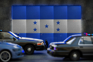 Bright digital display Honduras flag in city as cars drive past