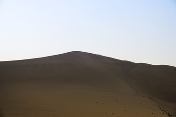 Desert with a blue sky. Beautiful curves of deserts