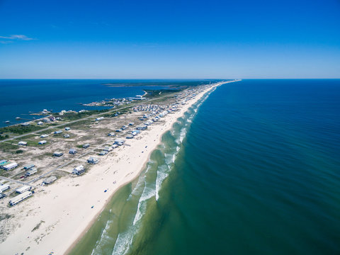 Drone/Aerial ocean photograph of the Gulf Shores/Fort Morgan peninsula.  The warm Gulf of Mexico washes onto this pristine white sand beach.  Alabama, USA 