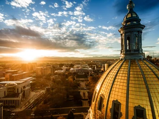 Foto op Canvas Aerial/Drone photograph of a sunset over the Colorado state capital building.  Capital city of Denver.  The Rocky Mountains can be seen on the horizon © nick