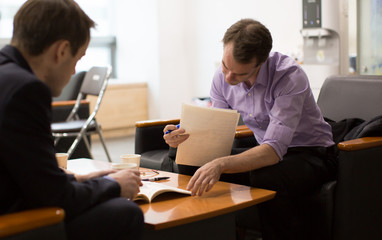 Business Meeting with People Reviewing Business Plans. Job Interview by Hiring Manager. Expert Businessmen. Career Legal Advisor is Reading and Presenting Documents to Client or Employee.
