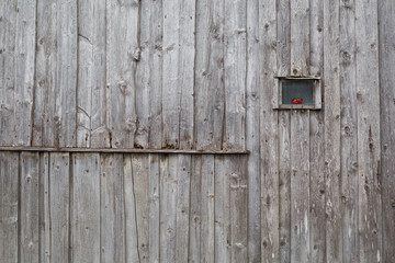 old wooden wall with a tiny window