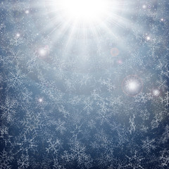 Midnight of Christmas snowflakes time with sun burst effect background.