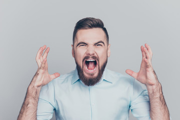 Closeup photo portrait of aggressive crazy mad bad furious man gesturing with hands isolated on grey background