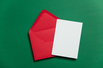 Blank white card with red paper envelope Christmas card template mock up.