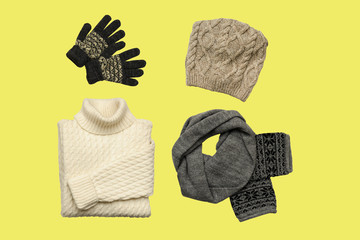 Set of sylish winter clothes on colour background with hat, mittens, sweater, scarf. flat lay, top view
