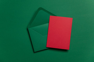 Blank red card with green paper envelope Christmas card template mock up.