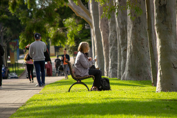 Woman in a bank at the park having a rest