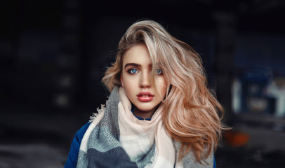 Portrait of a beautiful blonde girl with expressive blue eyes