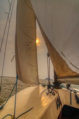 The setting sun seen through the sails