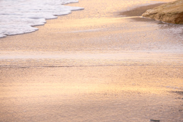 waves on beach at sunset