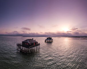 Fishermen houses in Bassin Arcachon, Cabanes Tchanquees, Aerial view, France - obrazy, fototapety, plakaty