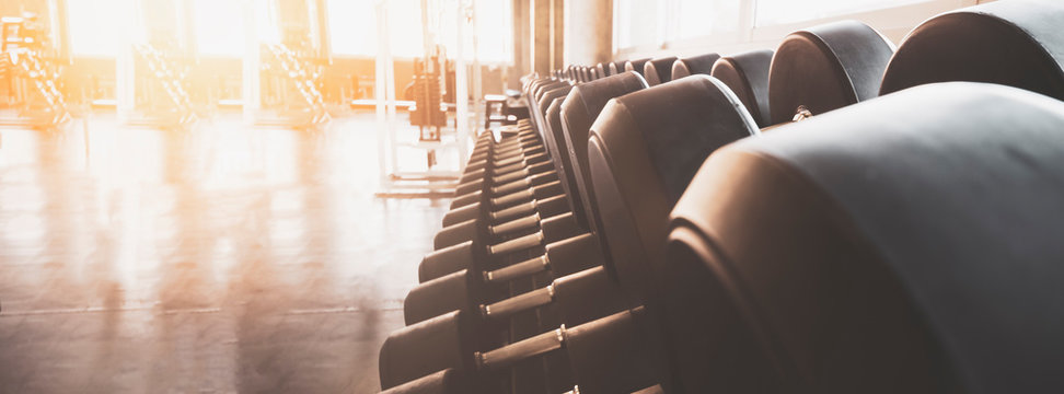 Gym Equipment Wide Interior Gym For Fitness Banner Background Close Up Dumbbells And Blurred Equipment