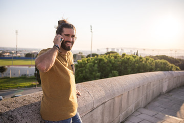 young man with long hair using his mobile phone