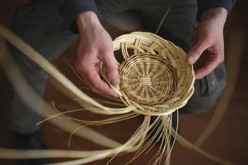 Basketwork from willow twigs in the workshop. - obrazy, fototapety, plakaty