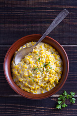 Sweet and creamy skillet corn. Homemade corn dish. View from above, top studio shot