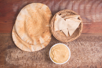Chickpeas hummus in a bowl and arab bread