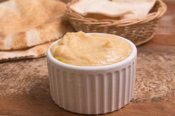 Chickpeas hummus in a bowl and arab bread