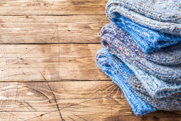 Fototapeta na wymiar Warm wool knitted socks for cold winter on wooden background. Copy space