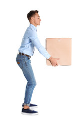 Full length portrait of young man lifting heavy cardboard box on white background. Posture concept