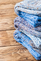 Warm wool knitted socks for cold winter on wooden background. Copy space