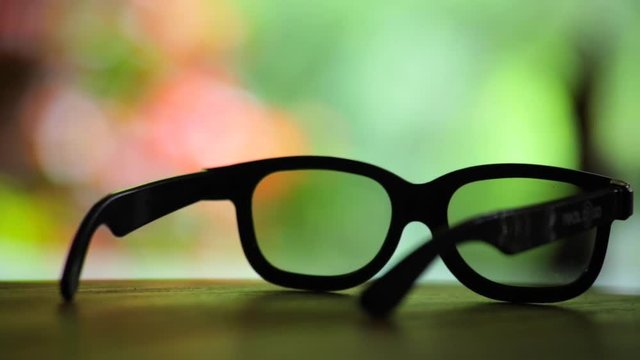 Sunglasses on a table over looking colourfull natrual setting