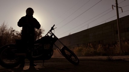 Naklejka na ściany i meble Motorbike silhouette with unknown person 
