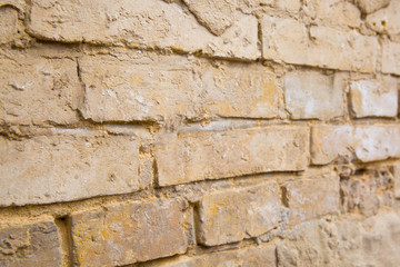 Part of old brick wall with crumbled plaster, close up