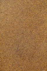 Small yellow stones on the road surface as background