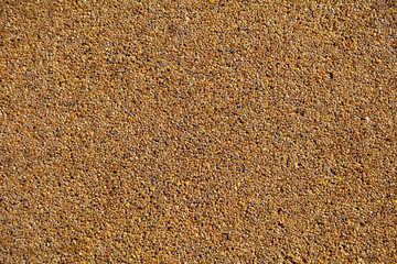 Small yellow stones on the road surface as background