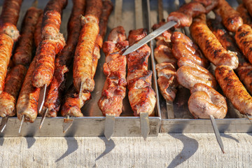 Grilled kebabs on metal sticks in nature