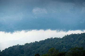 Obraz premium Green peaks and rain clouds