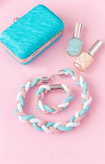 Beauty blog concept. Woman  accessories: bracelet, nail polish, necklace,  on the pink background. Flat lay, top view trendy fashion feminine background.