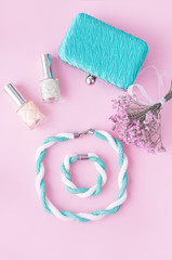 Beauty blog concept. Woman  accessories: bracelet, nail polish, necklace,  on the pink background. Flat lay, top view trendy fashion feminine background.