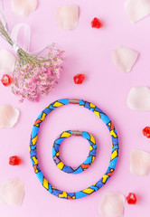 Beauty blog concept. Woman  accessories: bracelet, nail polish, necklace,  on the pink background. Flat lay, top view trendy fashion feminine background.