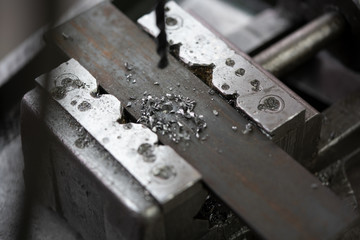 Drilling a hole into a piece of metal, close-up