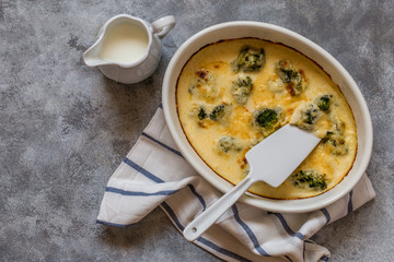 gratin with broccoli in white oval shape with béchamel sauce