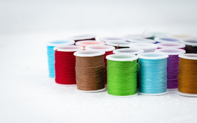 The colorful roll of thread on background,needlework,craft,sewing and tailoring concept