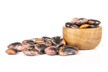 Lot of whole speckled colored butter beans painted lady scarlet runner variety and heap near with wooden bowl isolated on white background