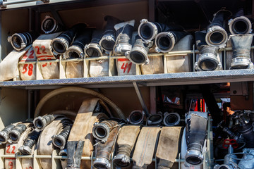 Rescue fire truck equipment. Compartment of the rolled up fire hoses on a fire engine