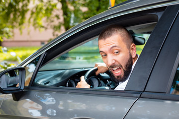 Angry businessman driving a car