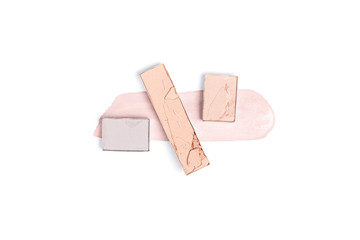 top view of pink and purple eyeshadows with stroke on white backdrop