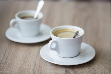 cup of coffee on a table in a cafe close-up with shallow depth of field