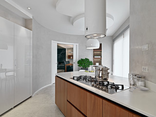 modern kitchen interior in the foreground the cooking hob with a steel pan, overlooking on the...