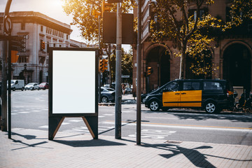 Outdoor empty informational board placeholder with a road and taxi car behind; white blank city...