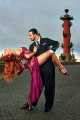 Young, beautiful and professional couple dancing tango in Saint-Petersburg at Vasilyevsky Island on...