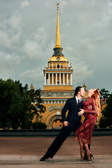 Young, beautiful and professional couple dancing tango in Saint-Petersburg of the Admiralty...