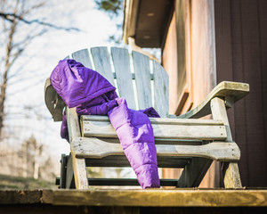 Purple Winter Coat Draped over an Aqua Adirondack Chair