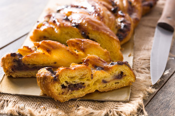 Homemade braid chocolate on wooden table. Close up